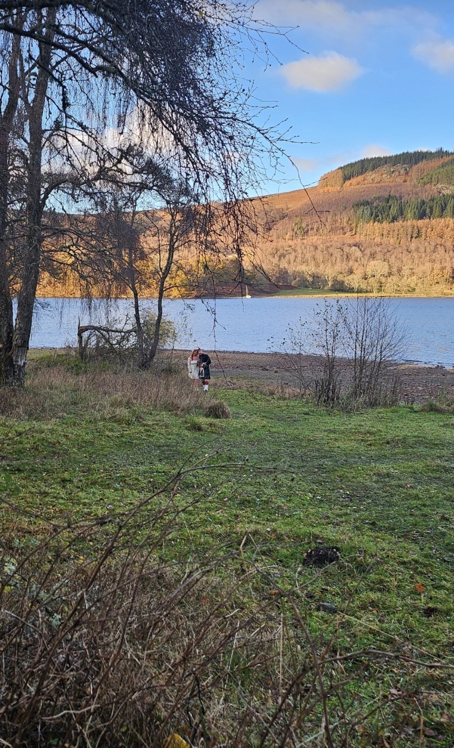 A couple sharing an intimate ceremony beside a lake
