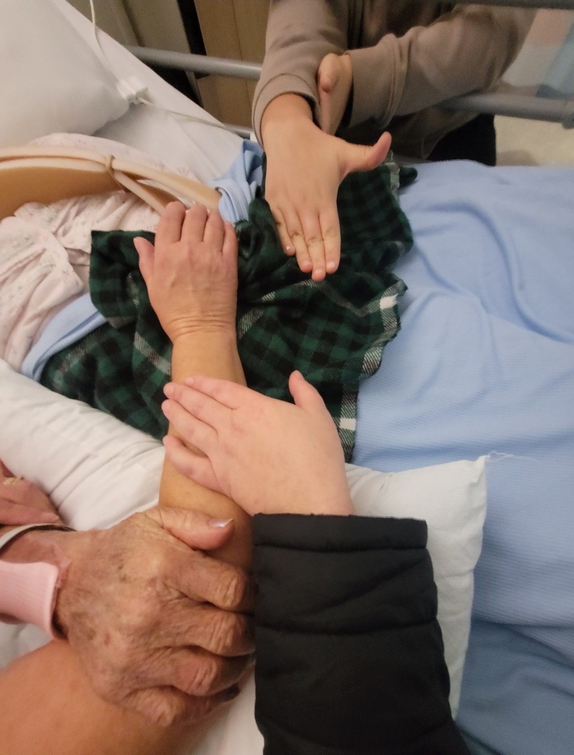 Family members holding hands in support
