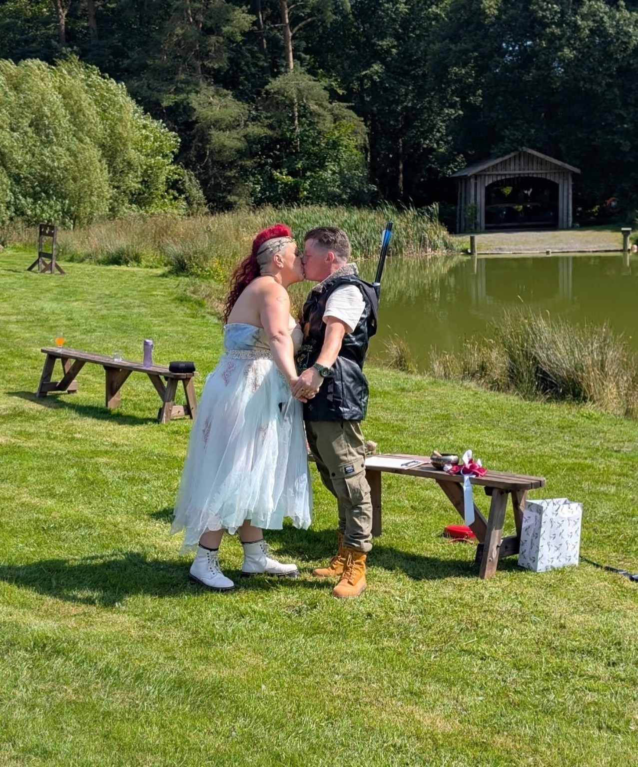 A couple sharing a kiss beside a loch during their vow renewal